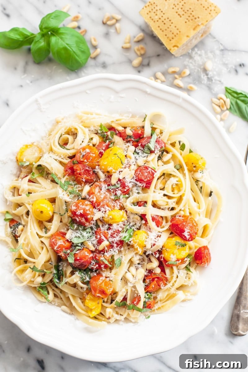 Fettuccine tossed with vibrant roasted cherry tomatoes and fresh basil, garnished with pine nuts and Parmesan.