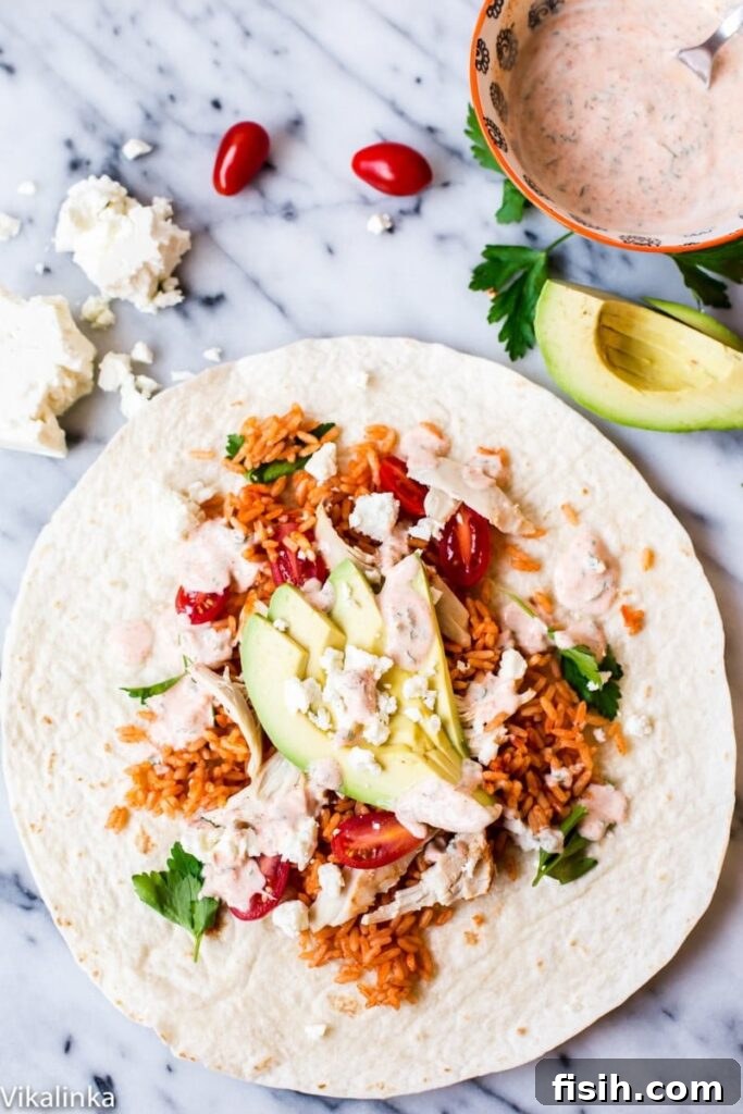 Open Peri Peri Rice and Chicken Wrap on a rustic wooden table, showcasing its vibrant fillings