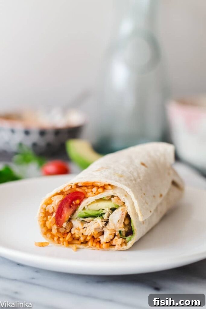 A perfectly rolled Peri Peri Rice and Chicken Wrap presented on a clean white plate, ready to eat