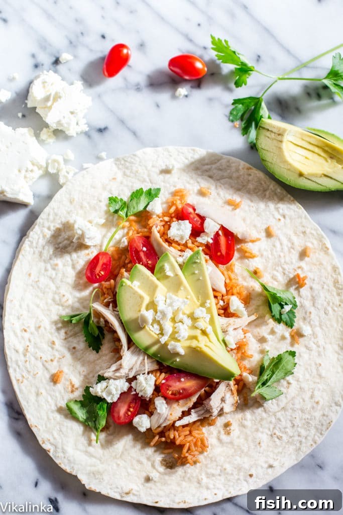 Open Peri Peri Rice and Chicken Wrap with additional avocado slices on the side, ready for customization