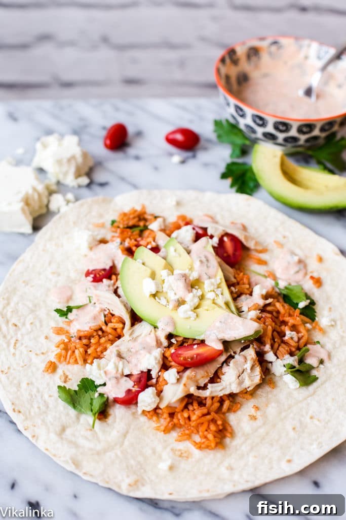 A close-up shot of a Peri Peri Rice and Chicken Wrap, showcasing its rich fillings and promising a delicious and exciting lunch