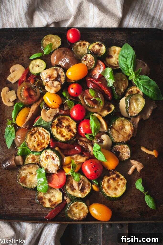 Warm zucchini salad with grilled red peppers, mushrooms, and cherry tomatoes, drizzled with balsamic vinaigrette. A healthy and flavorful summer dish.