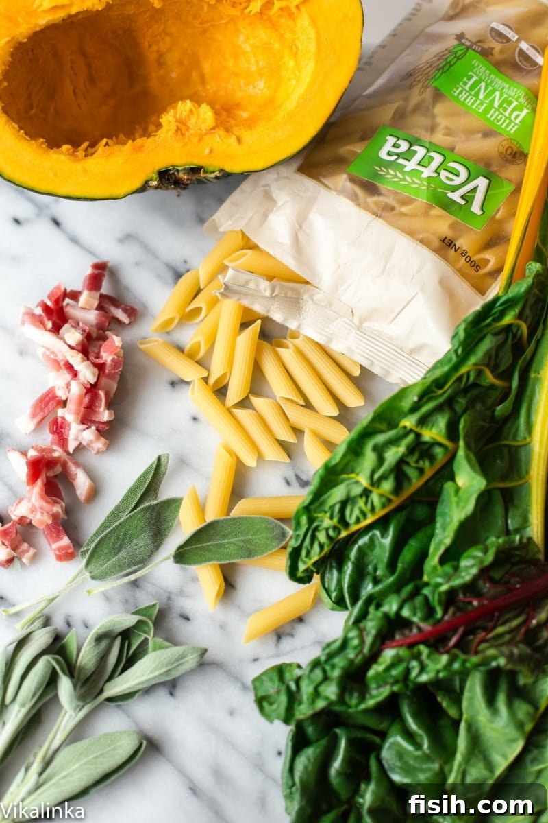 Penne pasta, fresh Swiss chard, roasted squash, and fragrant sage leaves, ready to be combined.