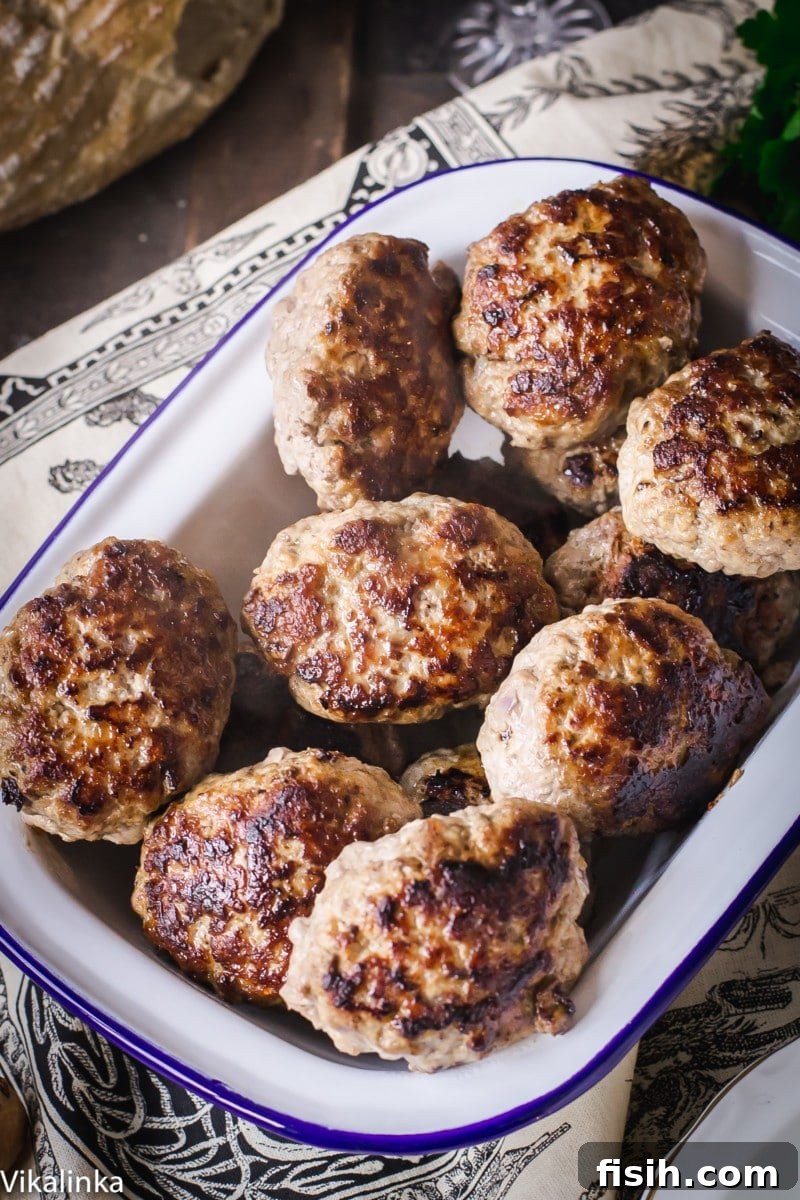 Savory Kotlety with Woodland Mushroom Sauce 3 meat patties in white enamel dish