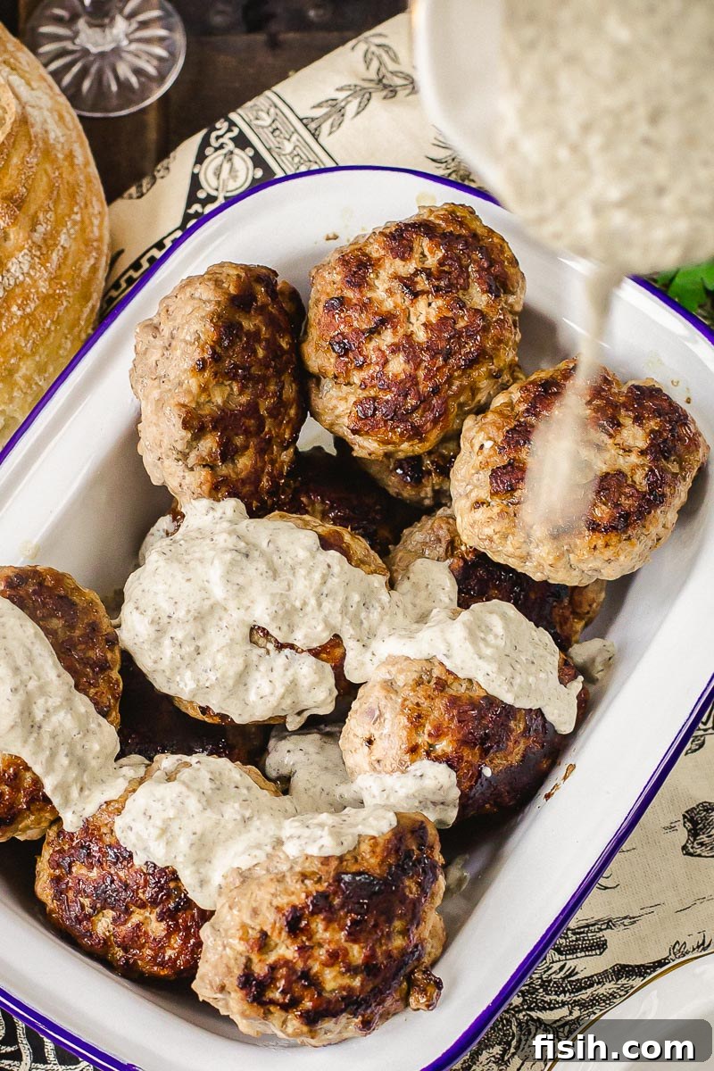 Savory Kotlety with Woodland Mushroom Sauce 4 beef cutlets with sauce being poured over them