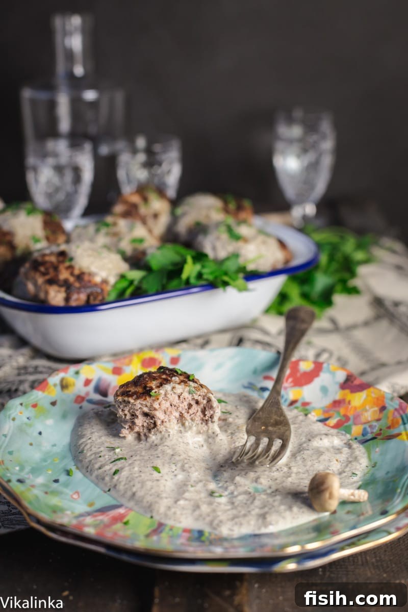 Savory Kotlety with Woodland Mushroom Sauce 6 beef patty with creamy sauce on a blue plate