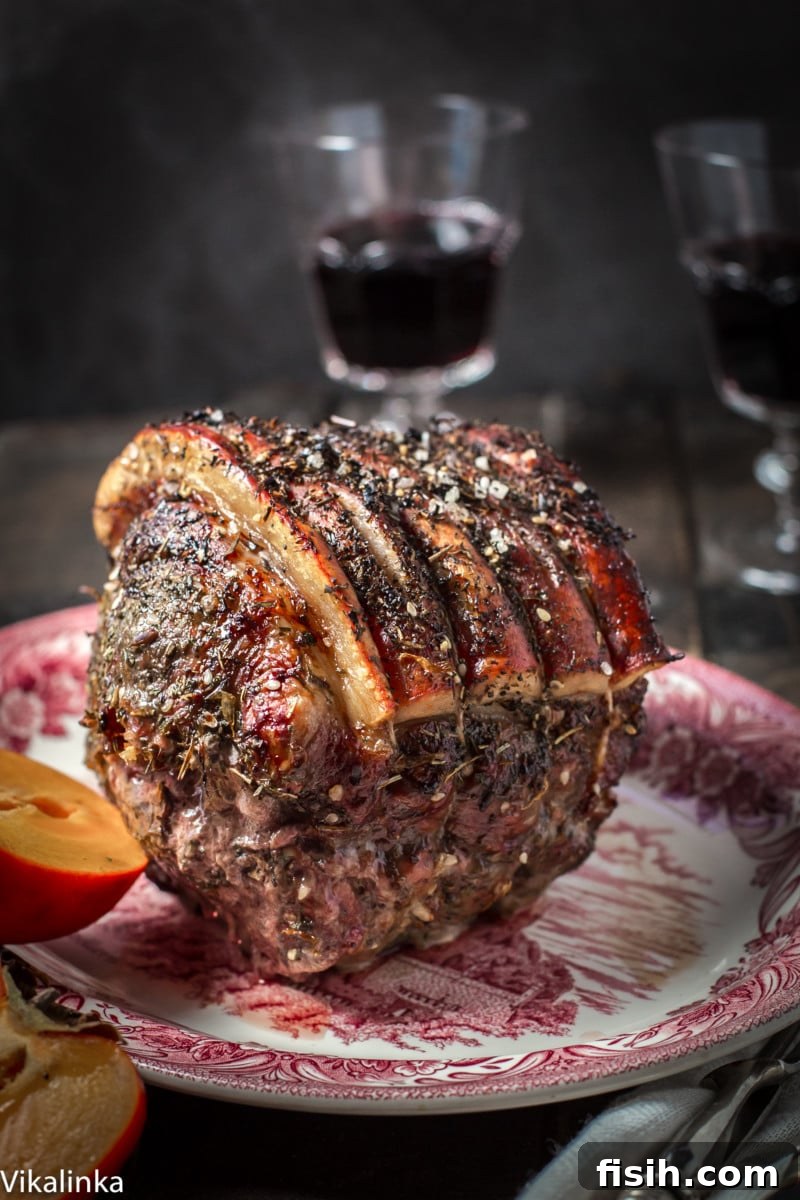 Cooked pork roast on a wooden serving platter, with a sliced persimmon and a bowl of warm persimmon sauce