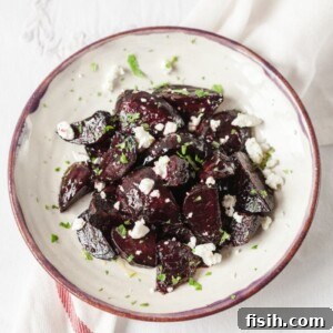 Top down view of beets with goats cheese and mint on a plate