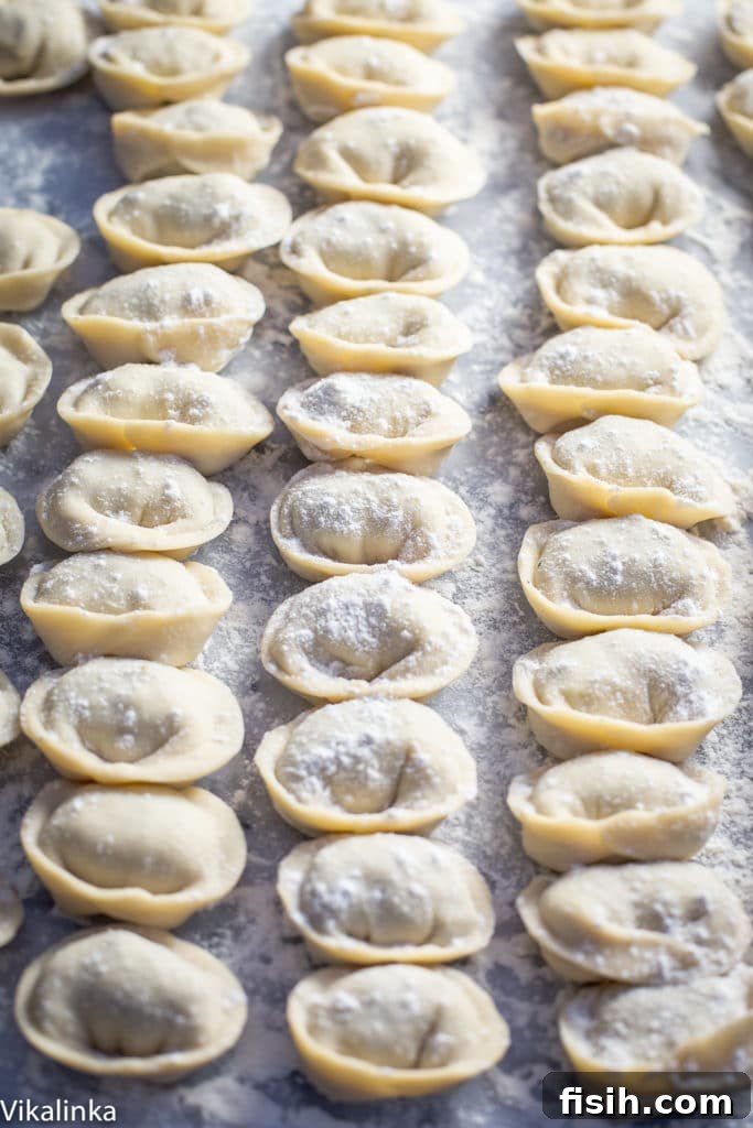 uncooked pelmeni on a floured surface