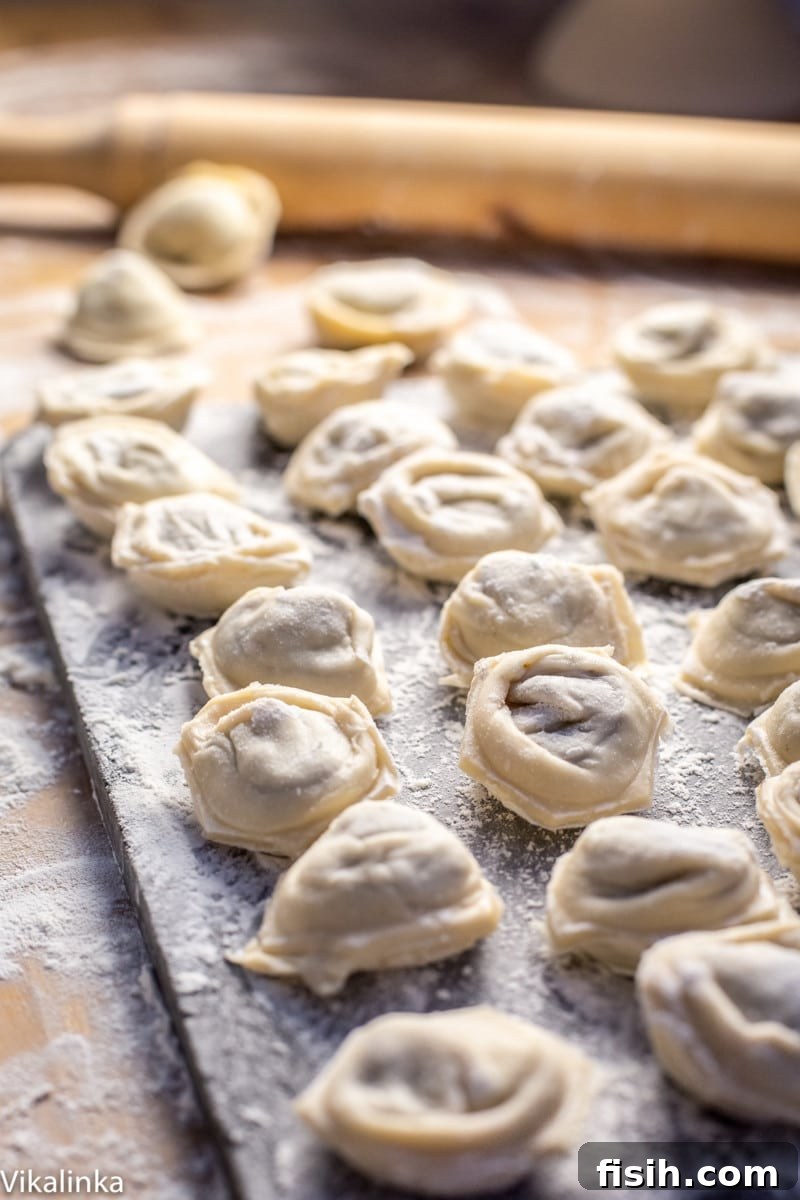 uncooked dumplings on a floured surface