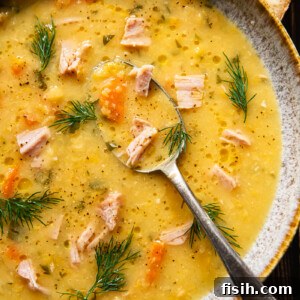top down view split pea and ham soup in a bowl with a spoon in it