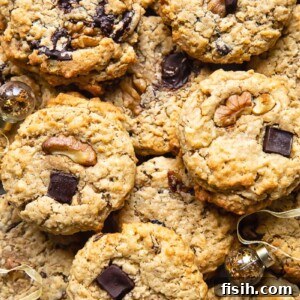 Top down shot of many cowboy cookies stacked on top of each other on a cutting board