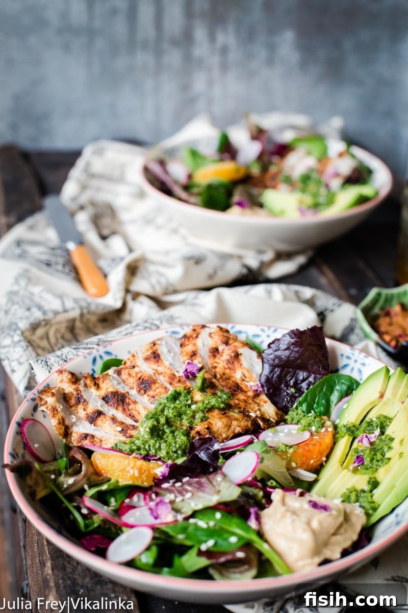 Eastern Mediterranean Mezze Bowl 2 Side shot of Middle Eastern Salad Bowl with grilled chicken, avocado, baba ganoush, zhoug, and pomegranate vinaigrette