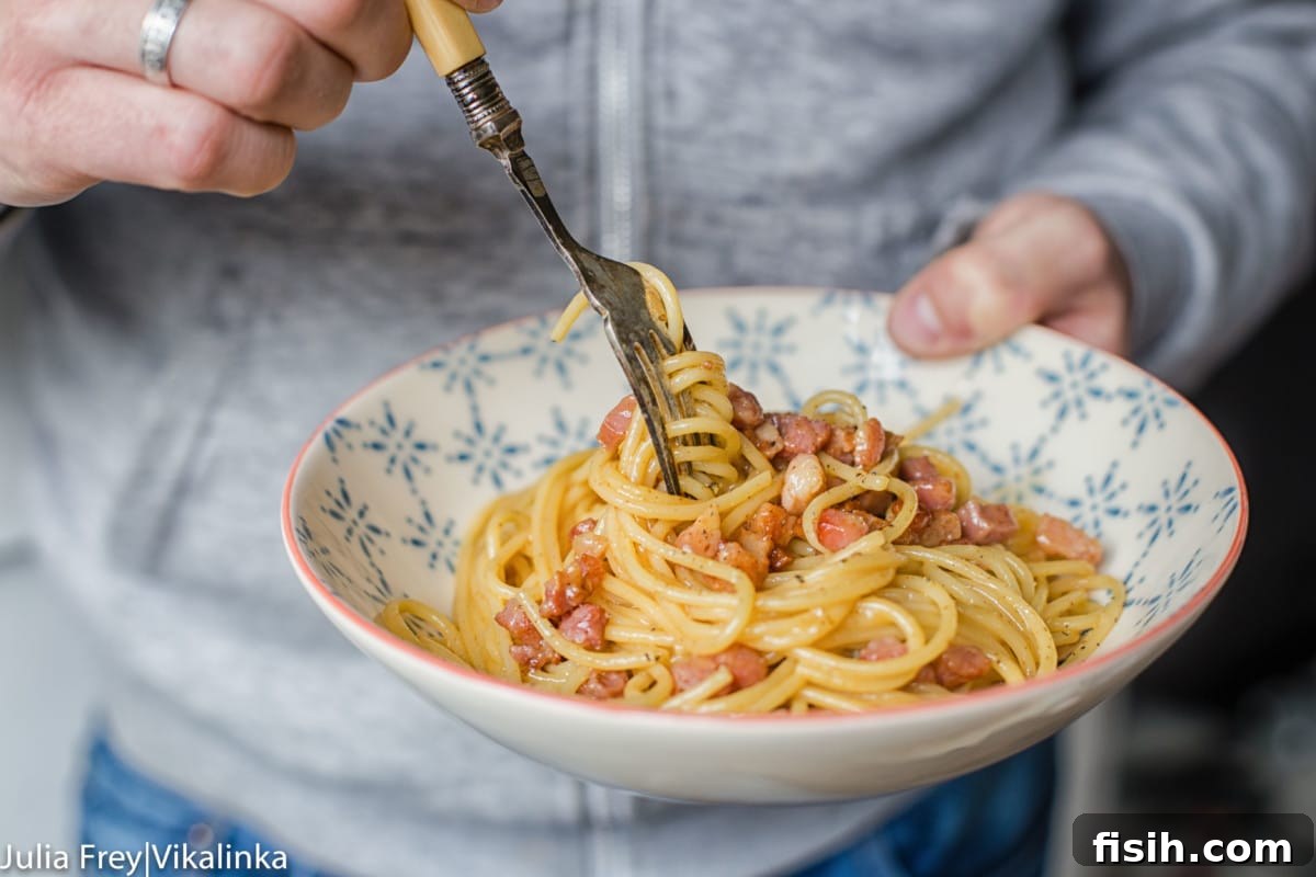 Hand holding pasta bowl