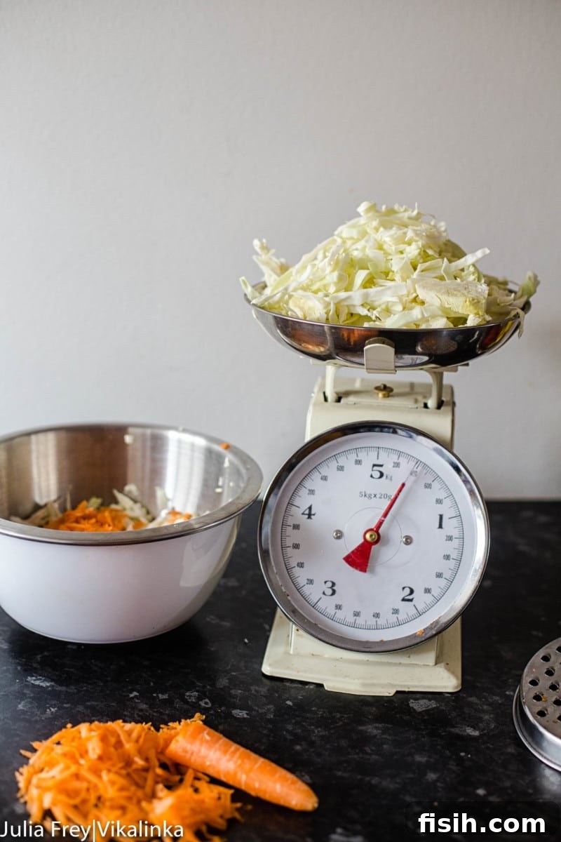 Process shot showing sliced cabbage and grated carrots, the primary ingredients for sauerkraut
