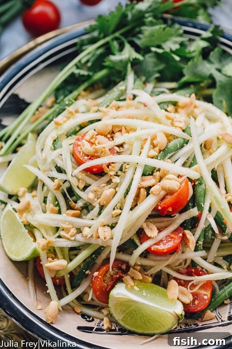 Close up of fresh noodles and tomatoes on a bed of greens, showcasing vibrant ingredients