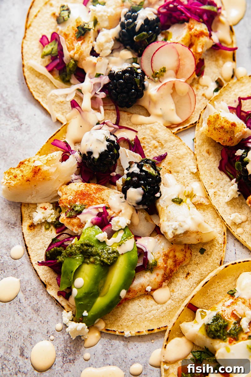 top down view of fish tacos with vibrant salsa and slaw