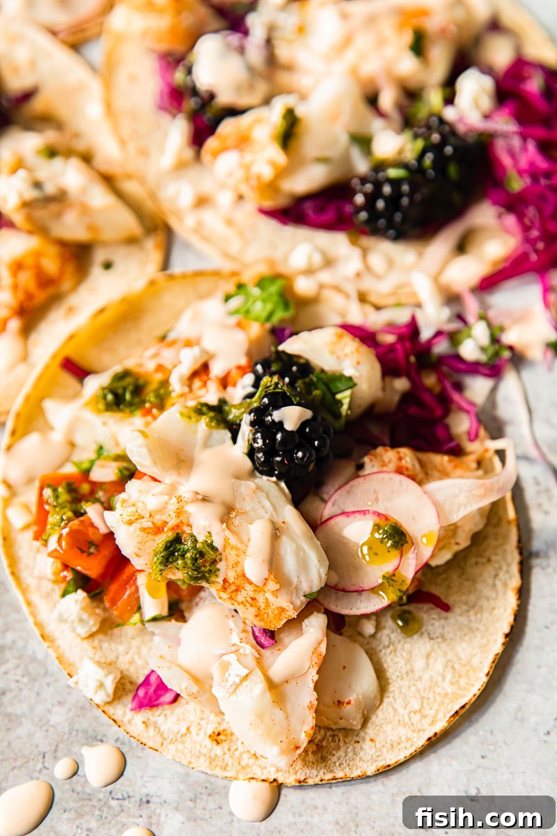 close-up view of a fish taco showing fish, slaw, and salsa