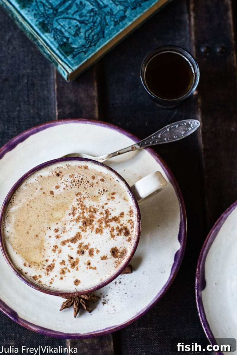 An overhead shot of a warm, inviting mug of latte, perhaps with a touch of artful foam, set on a rustic surface.