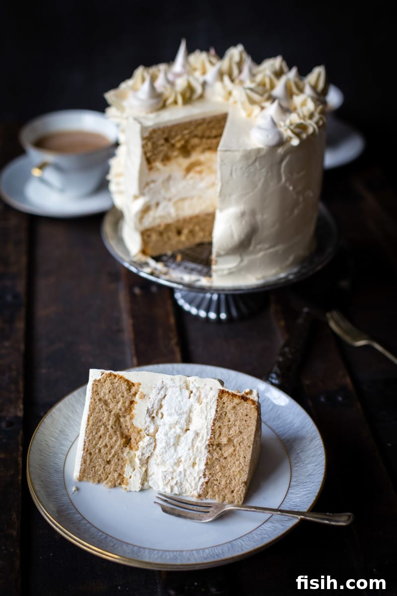 Ethereal Earl Grey Meringue 5 A piece of the Earl Grey meringue cake on a plate with the rest of the cake in the background, ready to be enjoyed.