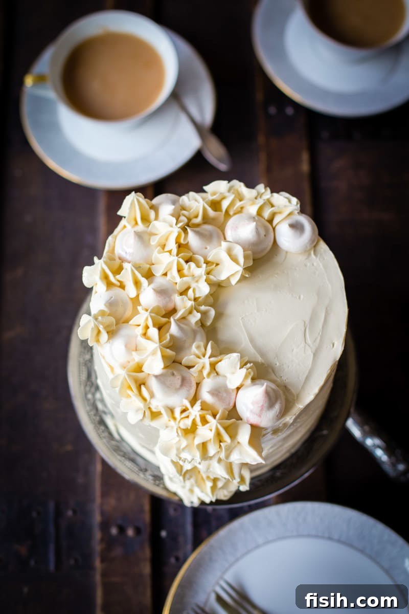 Ethereal Earl Grey Meringue 6 Top-down view of the cake with elegant tea cups arranged beside it, setting a sophisticated scene.