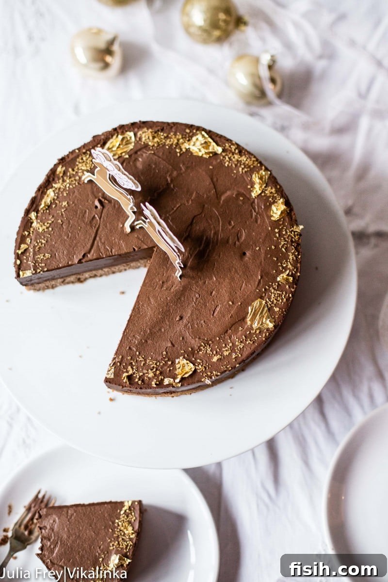 An overhead view of the decadent Dark Chocolate Truffle Cake with one slice carefully removed, revealing its rich layers.