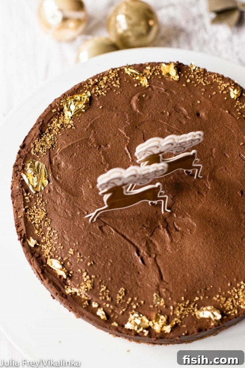 A close-up, top-down view of the elegantly decorated chocolate truffle cake, highlighting the edible gold leaf details.
