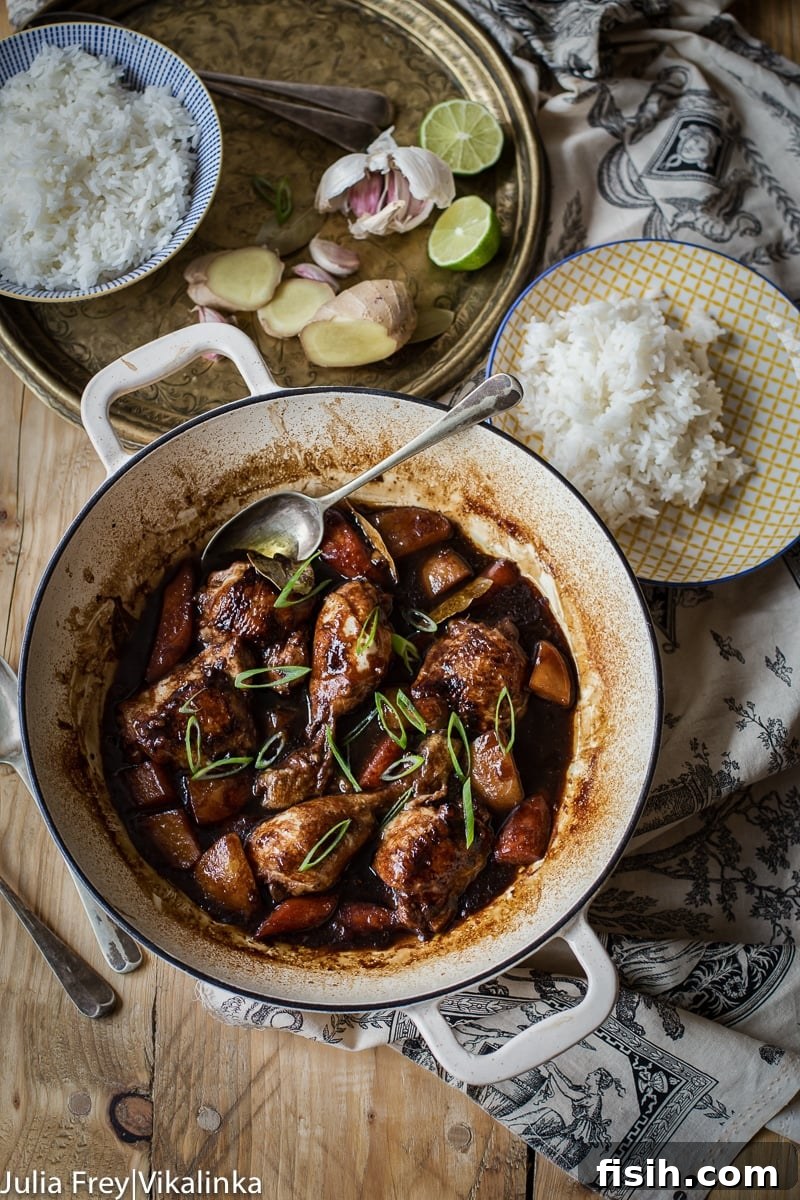 Iconic Filipino Chicken Adobo 5 Top down photo of Filipino Chicken Adobo simmering in a pot, highlighting the rich sauce and tender chicken.