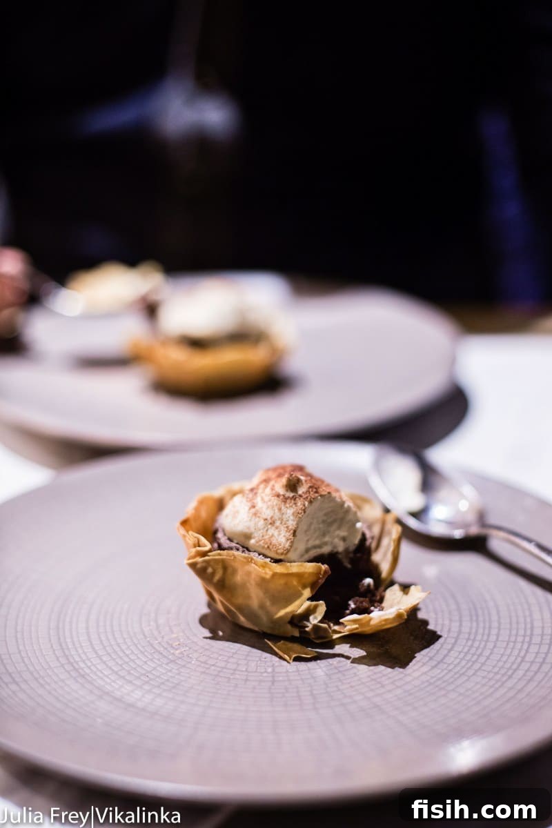 Chef preparing a delicate dish in a fine dining setting