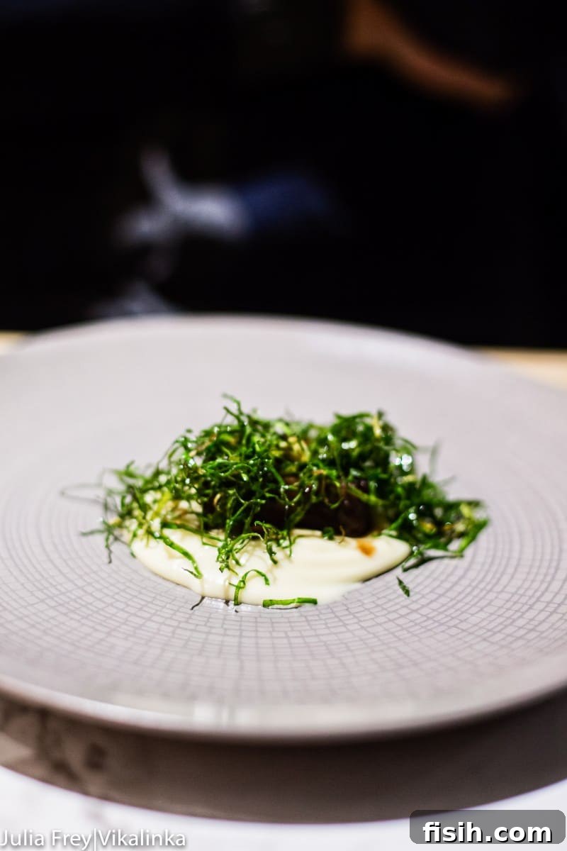 A small, exquisitely prepared dish, possibly a starter with a delicate garnish