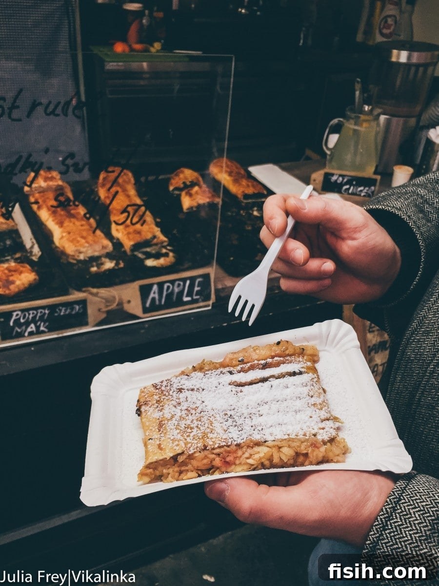 Traditional apple strudel with powdered sugar, served on a plate