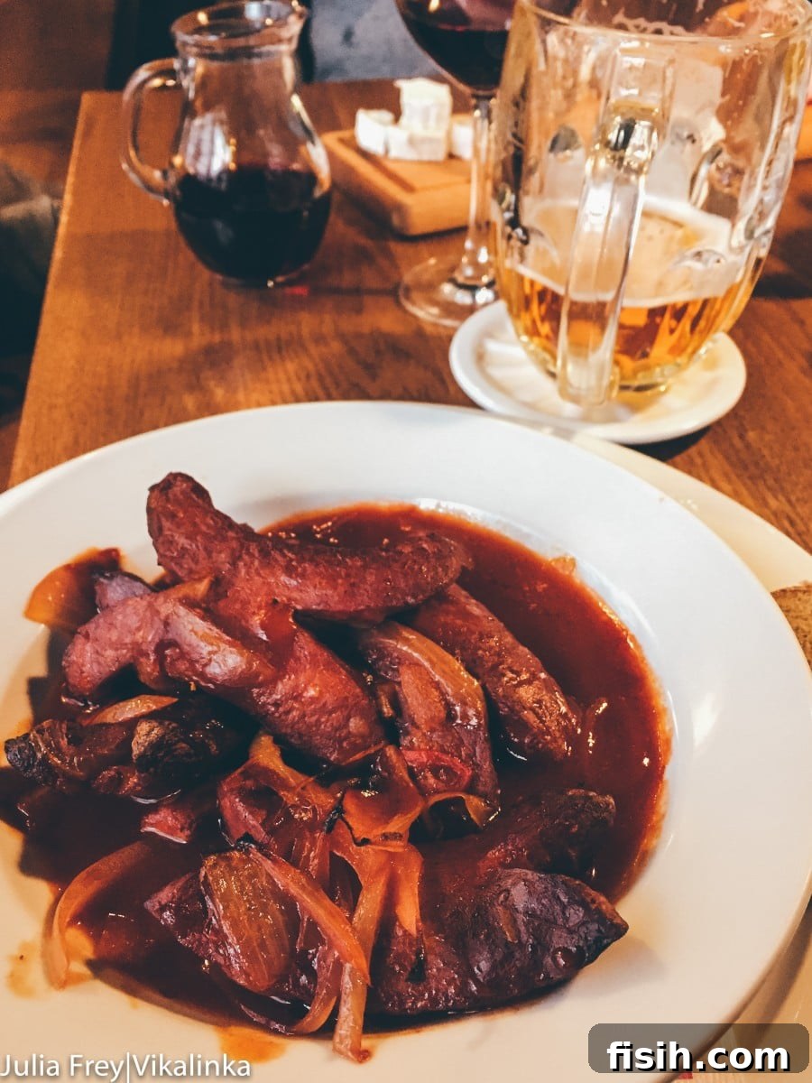 Traditional Czech goulash with dumplings in a rustic setting