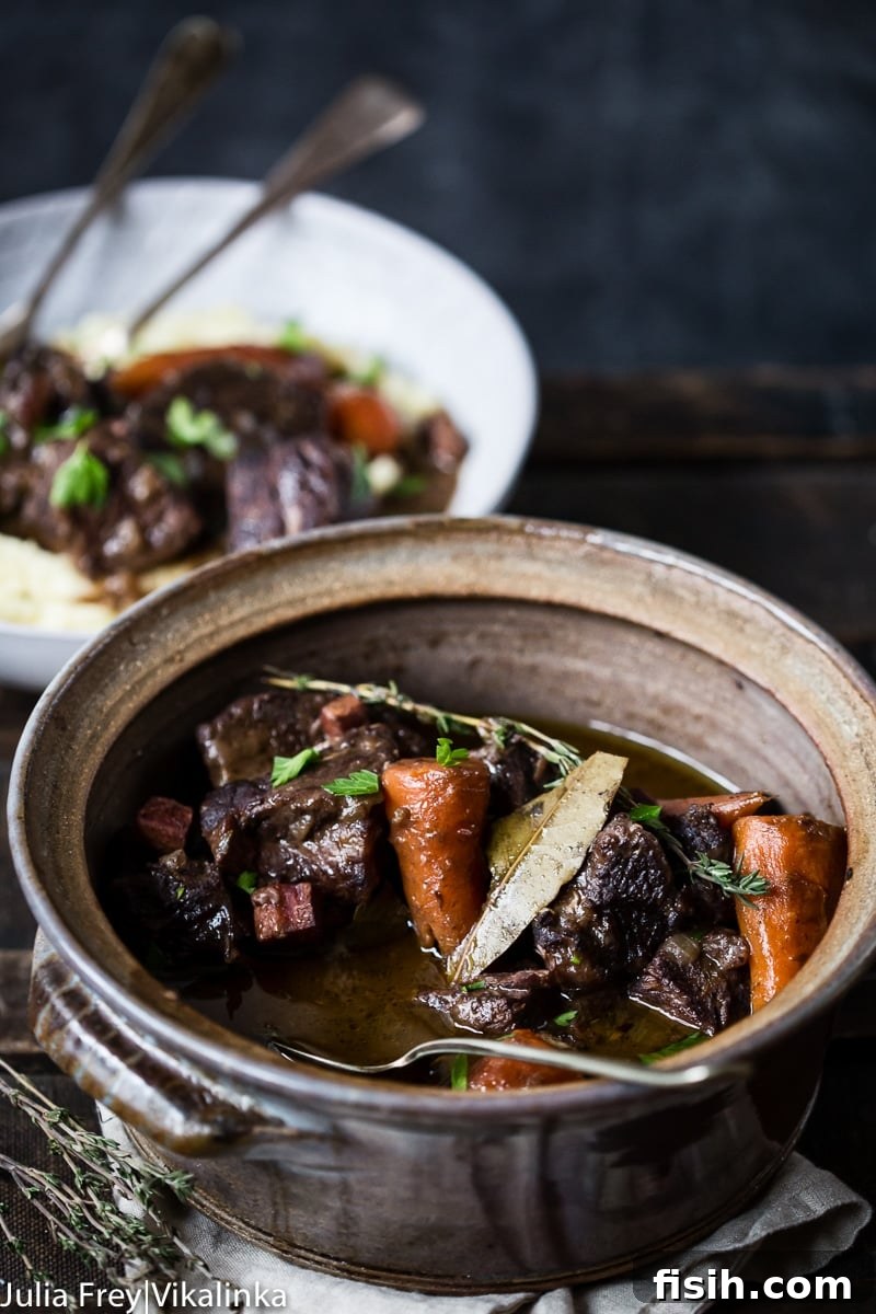 A beautiful serving dish filled with perfectly cooked Beef Bourguignon, ready to be enjoyed.