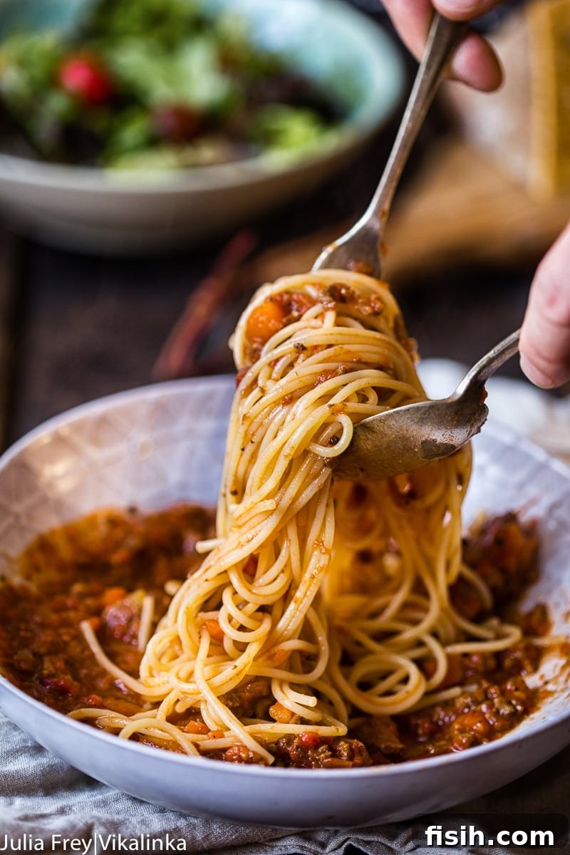 Effortless Slow Cooker Bolognese 5 Overhead view of slow cooker beef bolognese sauce, showcasing its rich texture before serving.