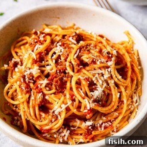 Effortless Slow Cooker Bolognese 8 Spaghetti bolognese sprinkled with Parmesan in cream bowl