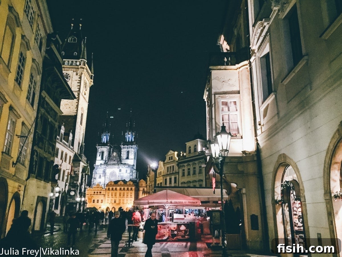 Old Town Square at night, vibrant and illuminated
