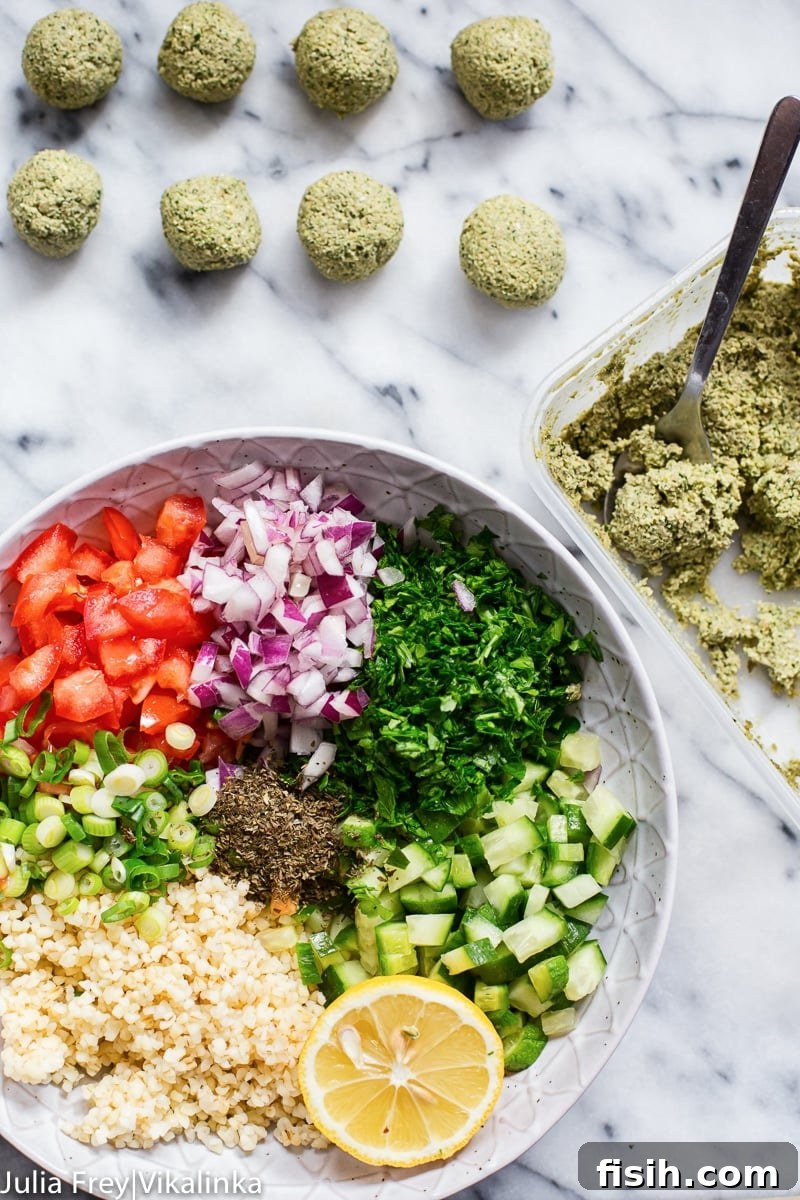 Process shot showing a variety of fresh ingredients for falafel salad