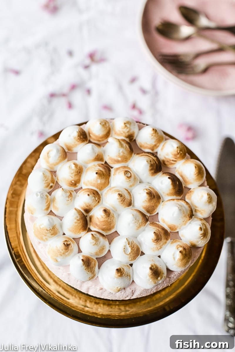 Top down view of cheesecake on a stand with cutlery below