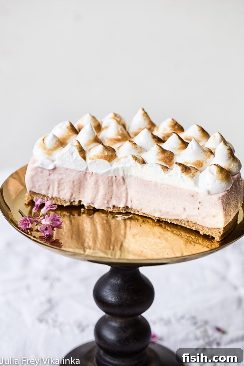 Side view of Strawberry Meringue Cheesecake with pieces removed