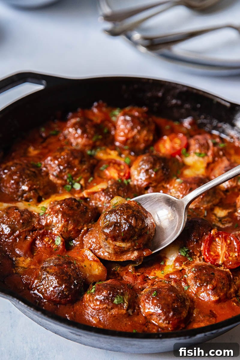 Baked Meatballs with Mozzarella and Arugula in a rich tomato sauce