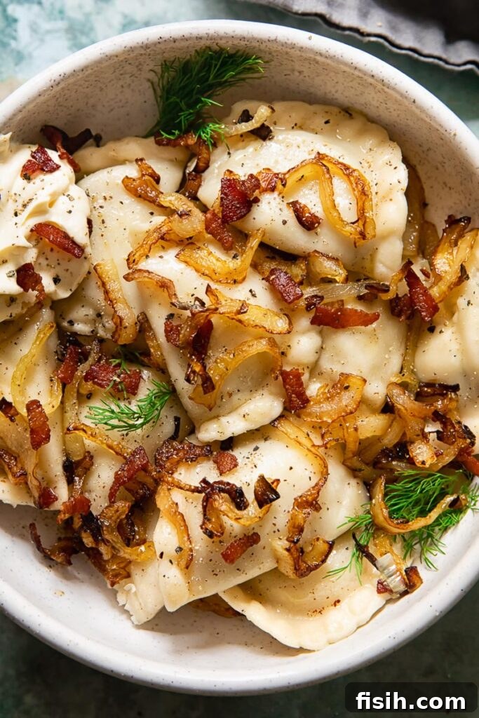 Smoky Bacon and Sweet Onion Potato Pierogi 2 A bowl of freshly cooked Vareniki, topped with crispy fried onions and bacon bits, ready to be enjoyed.