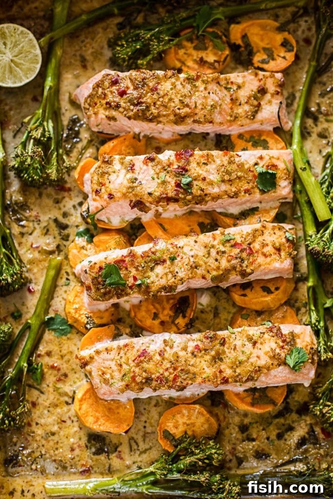 Fiery Garlic Salmon Skillet 2 Baking tray with salmon on top of vegetables, perfectly cooked and ready to serve.