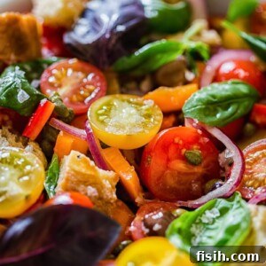 Rustic Tuscan Bread Salad 8 A fresh Panzanella salad with vibrant tomatoes and basil, beautifully presented in a white bowl.