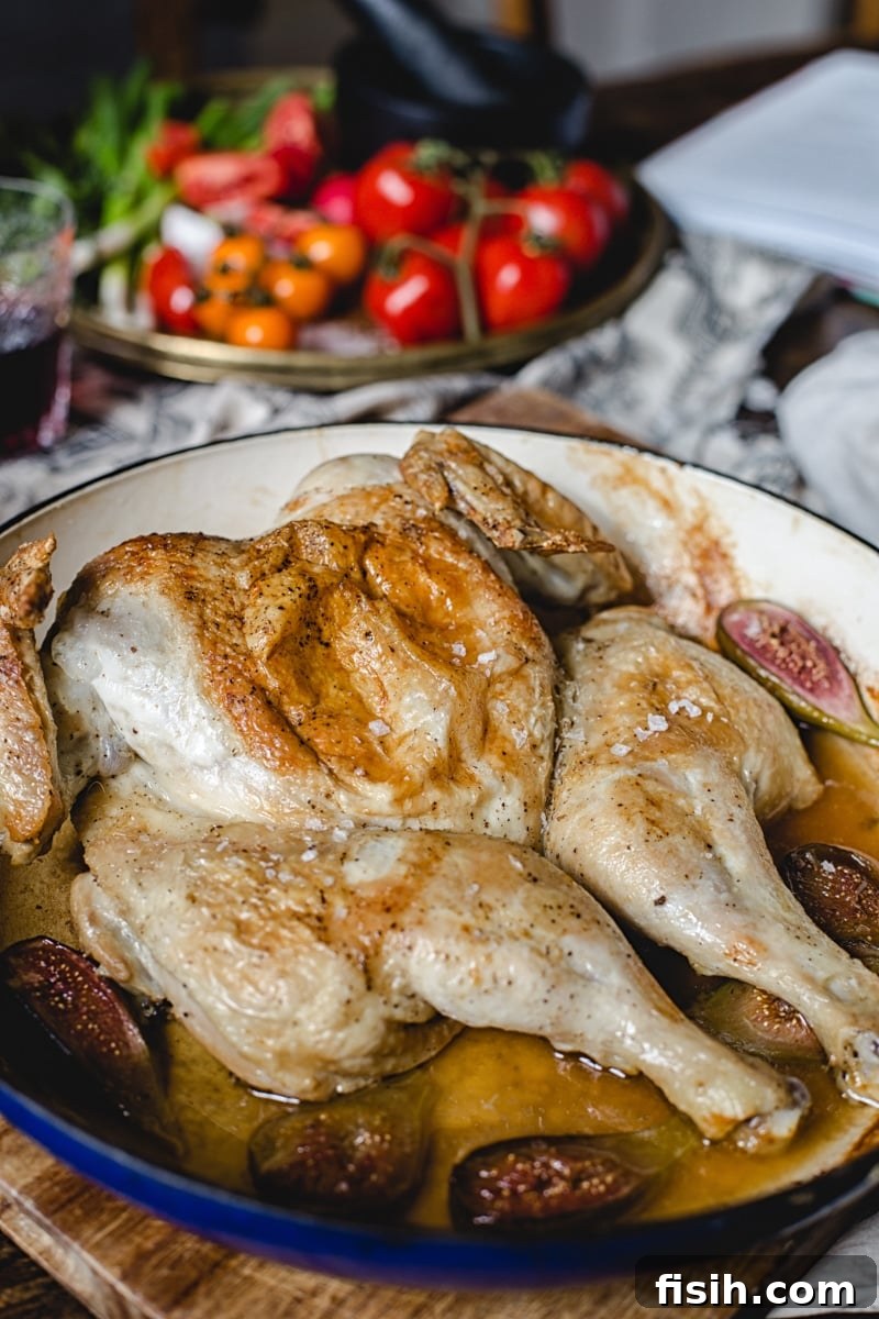 Georgian Tabaka Chicken with Fiery Blackberry Glaze 5 A spatchcocked chicken cooking under a heavy press in a cast-iron dish, showing the traditional method for Georgian Chicken Tabaka.