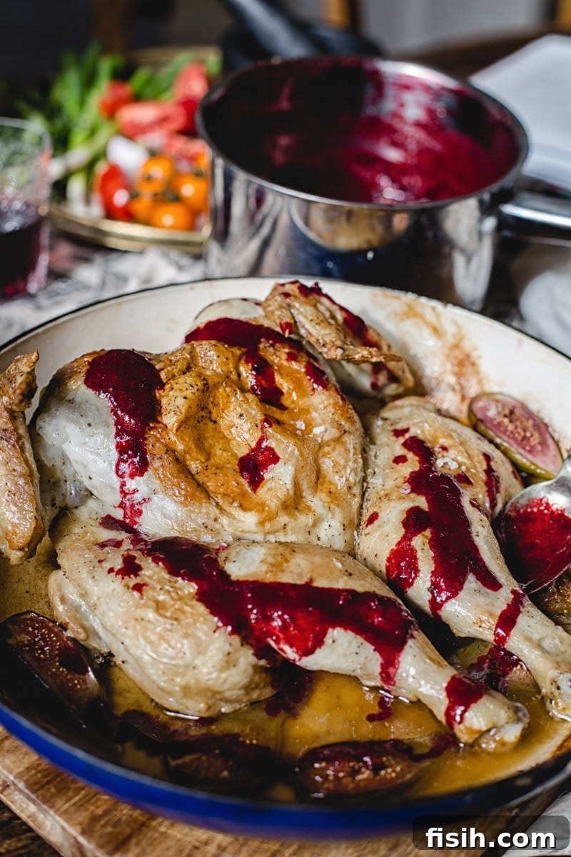 Georgian Tabaka Chicken with Fiery Blackberry Glaze 7 A dish of Georgian Chicken Tabaka served with a generous helping of the vibrant spicy blackberry sauce, ready to be enjoyed.
