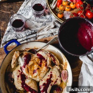 Top-down view of a beautifully presented Georgian Chicken Tabaka on a rustic wooden table, garnished with fresh herbs and a side of spicy blackberry sauce.