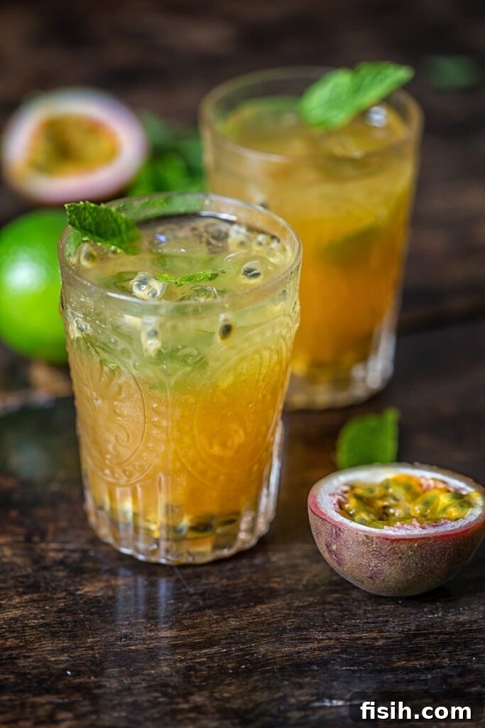 Vibrant Passion Fruit Mojito in a glass, garnished with mint and lime