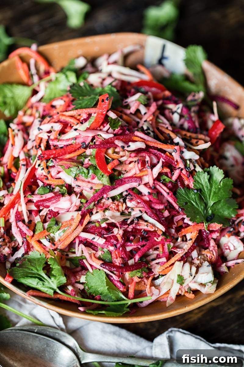 Vibrant Slaw, Zesty Tahini Delight 5 Close-up of vibrant, shredded vegetables in rainbow slaw, showing texture