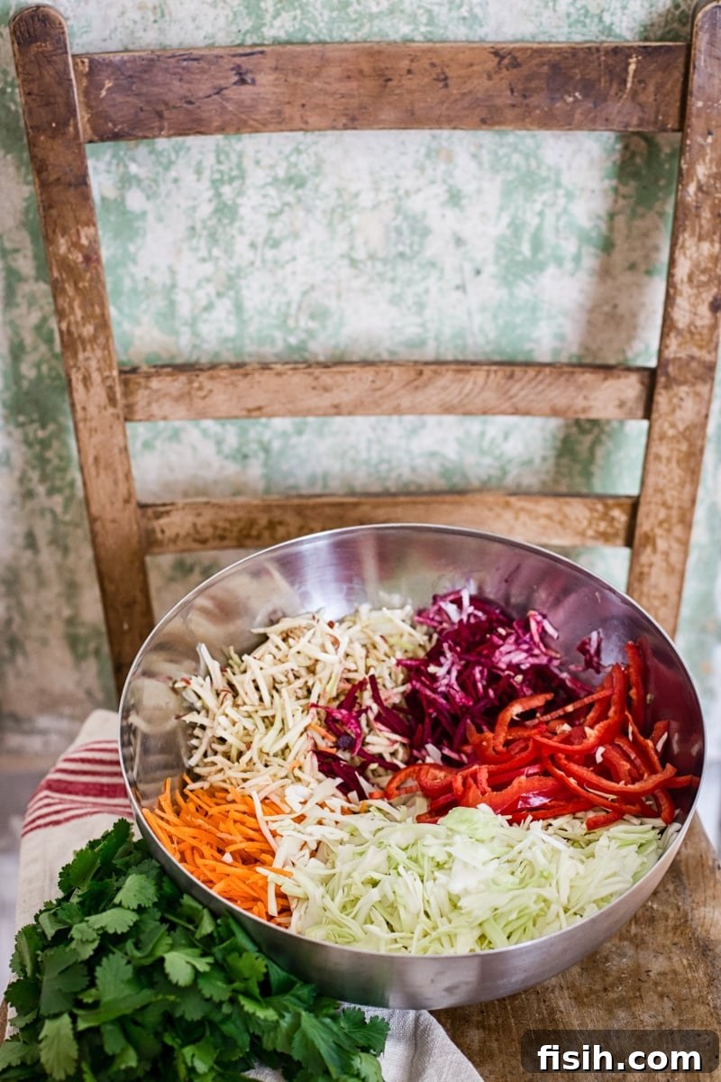 Vibrant Slaw, Zesty Tahini Delight 6 Large bowl filled with freshly shredded, colorful vegetables