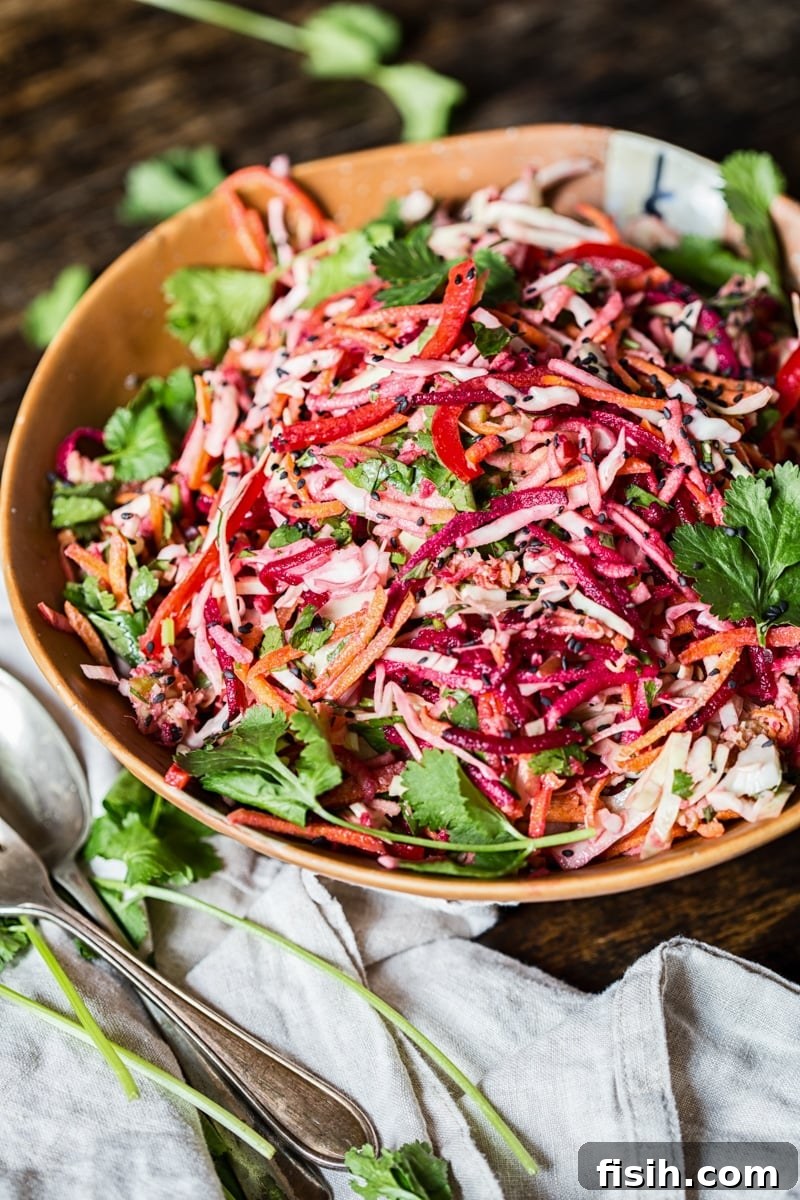 Vibrant Slaw, Zesty Tahini Delight 7 Bowl of rainbow slaw drizzled with lemon garlic tahini dressing